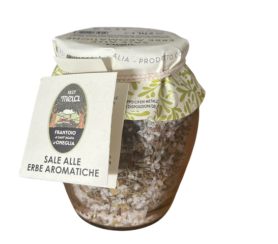 A glass jar of 167 Meia aromatic herb salt with a white paper label and a decorative green patterned neck wrap, set against a plain white background.